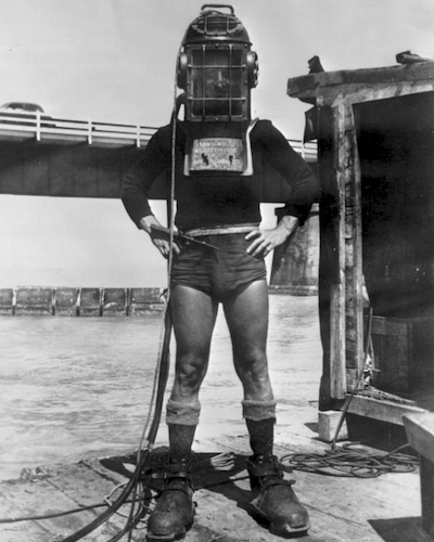 World War 2 era diver in diving suit with helmet.