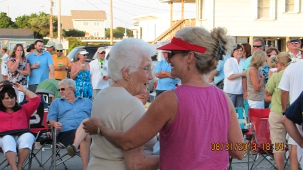 Bingo winner gets hug from local visor-wearing Cathy.